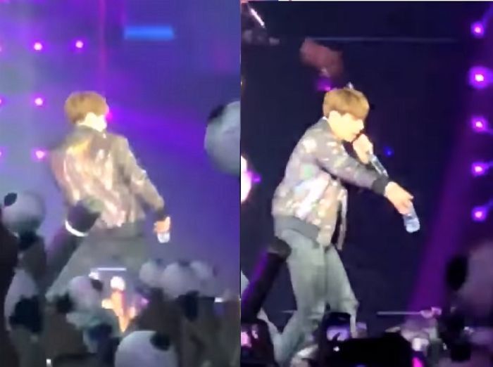 Jungkook memberikan botol minum kepada fans