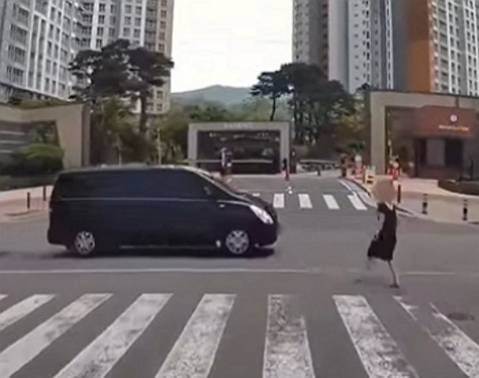 천천히 달려오는 승합 차 쪽으로 걸어와 혼자 부딪히더니 드러눕는 여성 (영상)