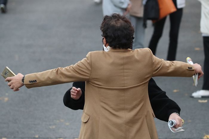 교문에서 초조하게 기다리다가 수능 마치고 나온 딸 꼭 안아주는 아버지