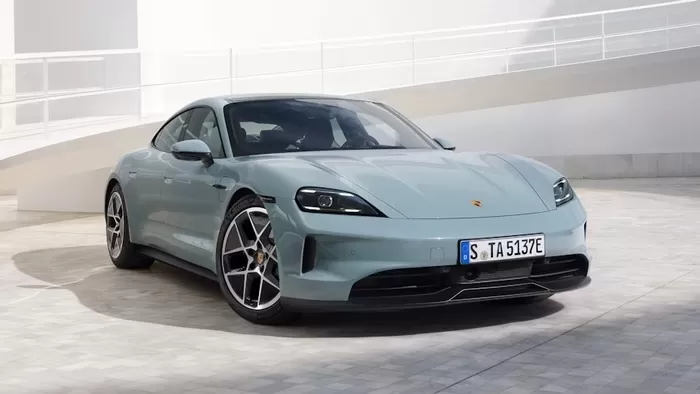 A sky blue Porsche Taycan in a minimalist urban setting with natural lighting