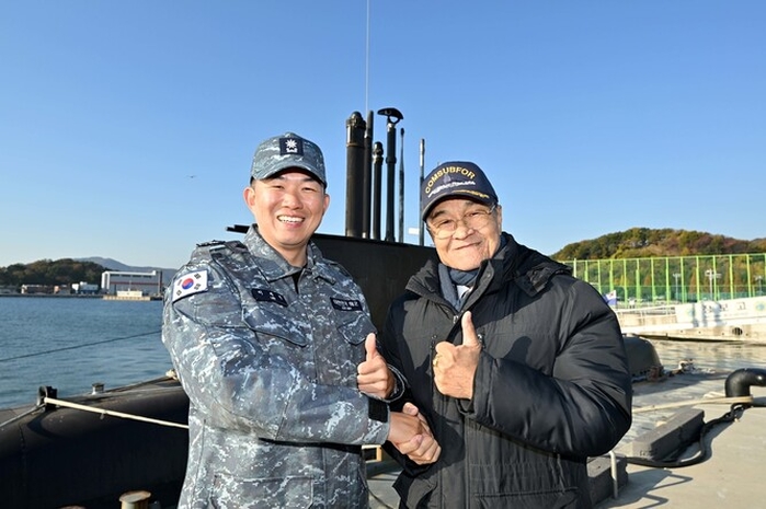 지난 19일 대한민국 1번 잠수함 장보고함의 마지막 항해를 앞두고 안병구 초대함장(오른쪽)과 이제권 장보고함장(왼쪽)이 진해 해군기지에 정박 중인 장보고함 앞에서 기념사진을 촬영하고 있다 / 해군 제공