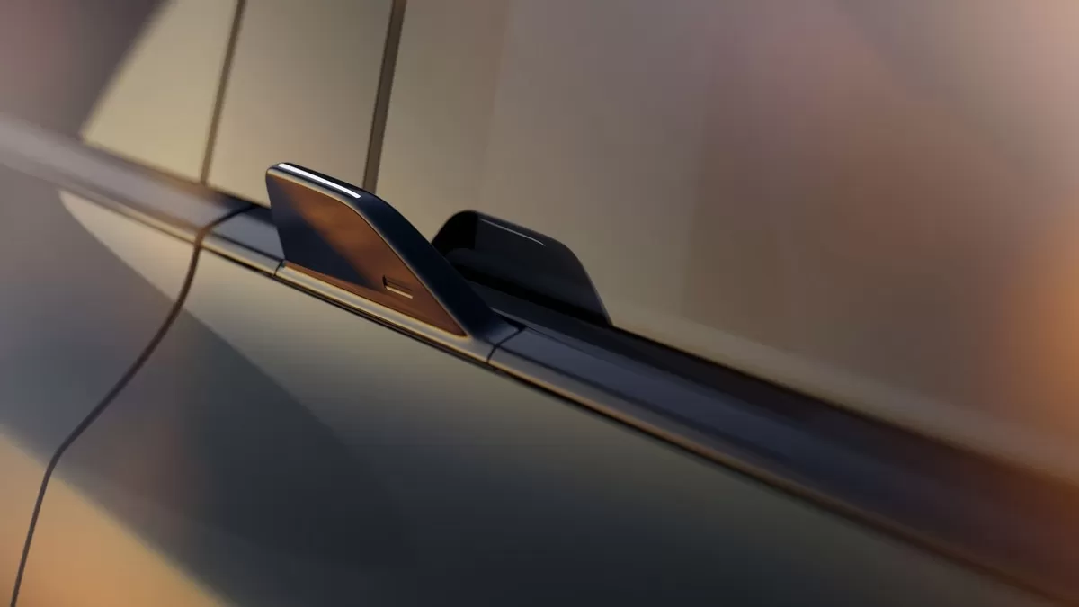 A close-up of the Volvo EX60 wing grip door handle in warm evening light.