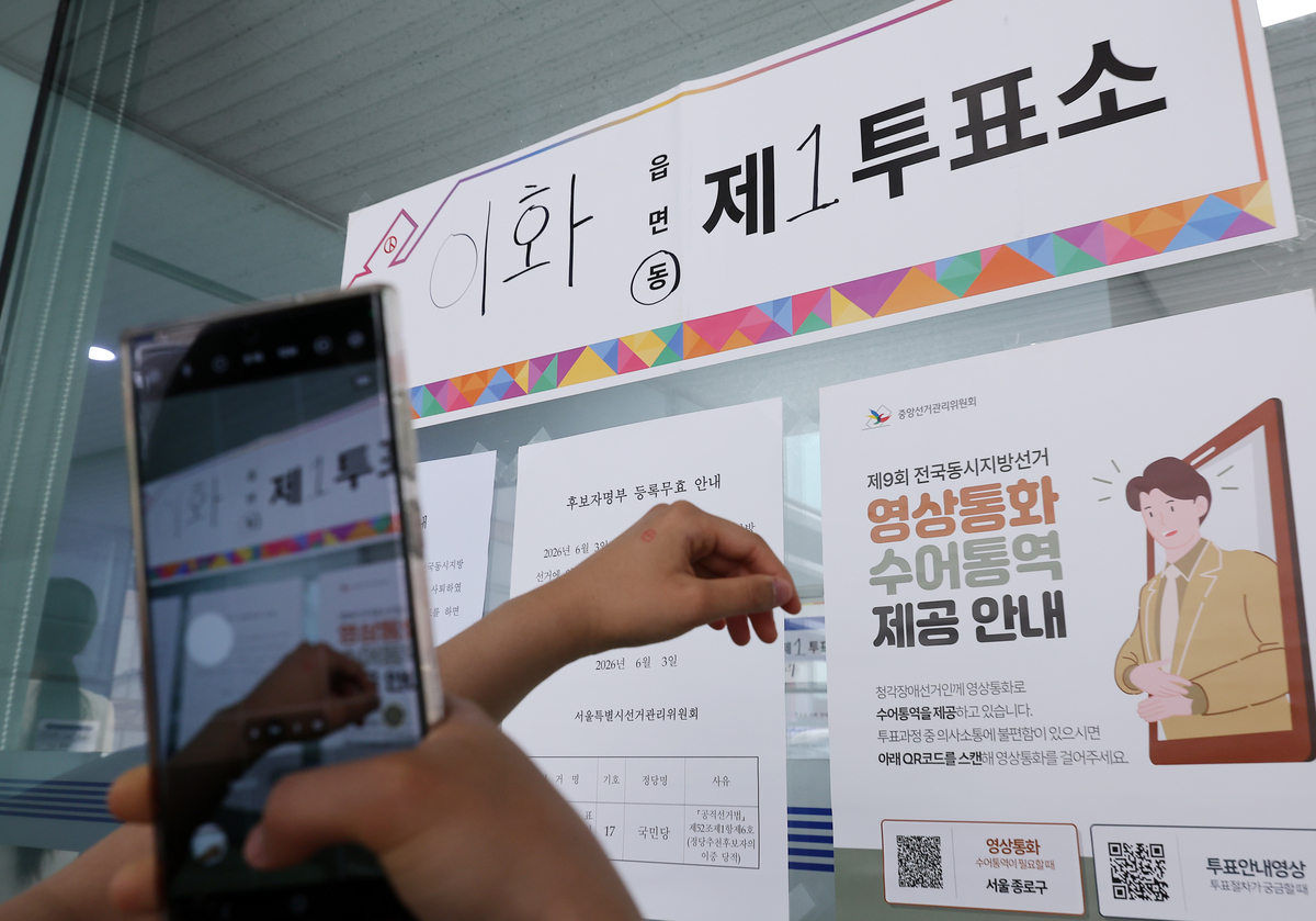 제9회 전국동시지방선거일인 3일 서울 종로구 상명대학교 예술디자인센터에 마련된 이화동 제1투표소에서 한 유권자가 인증샷을 남기고 있다 / 뉴스1