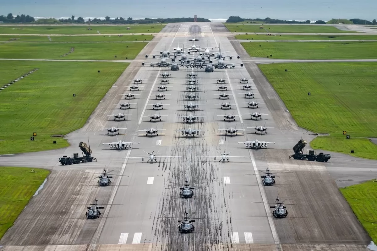 An aerial photograph of a large military elephant walk formation on a runway, showcasing a signif...